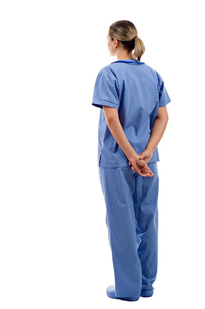 Doctor from the Back Female health care worker from the back - looking at something over a white background back to front stock pictures, royalty-free photos & images