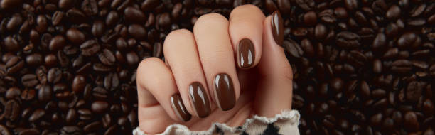 istock Beautiful groomed womans hand with brown nail design 1543463294