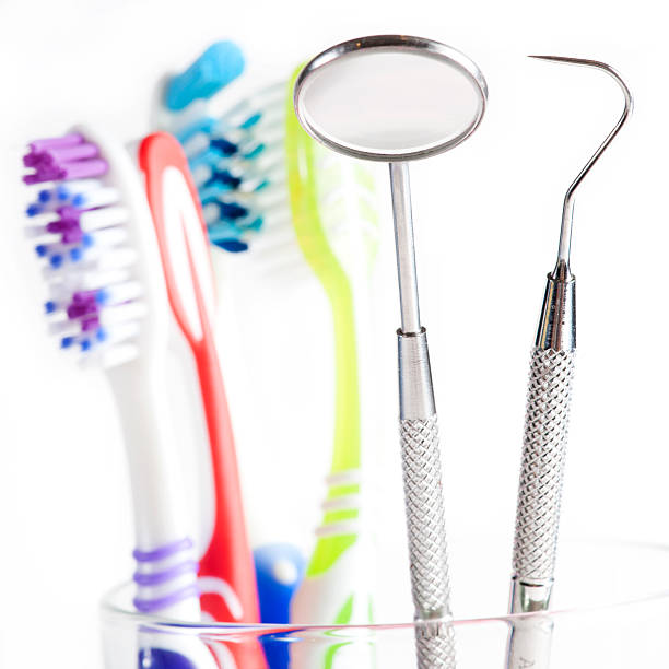 istock Toothbrush and Dental mirror - explorer in glass 154346813