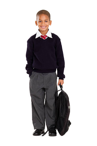 portrait of male elementary pupil on white full length studio portrait of male elementary pupil on white school uniform stock pictures, royalty-free photos & images