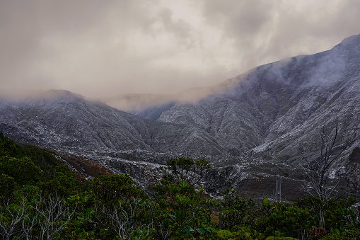 Beautiful nature view of the the Poas Volcano Canon, mountains and trial hick to the tourquoise waters with explorers