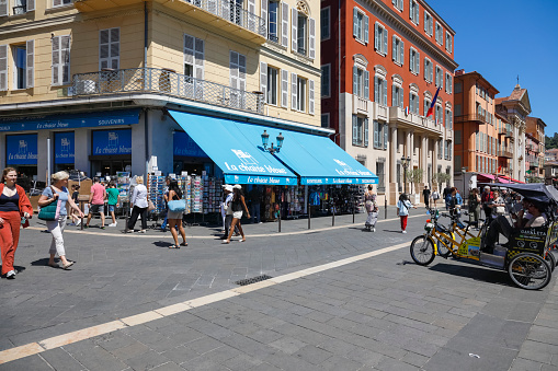 Nice, France - May 3, 2023: Mediterranean architecture on the example of buildings with balconies and shutters, located at the crossroads of pedestrian streets in the Old Town