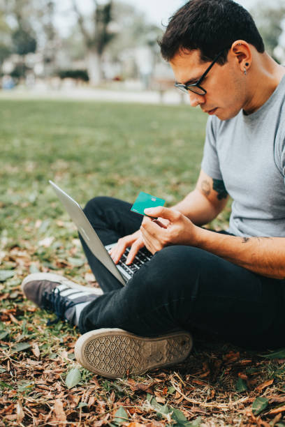 istock Man paying with his credit card on a laptop. 1543517121