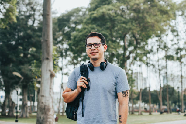 istock Young student with glasses and backpack in an outdoor park. 1543519020