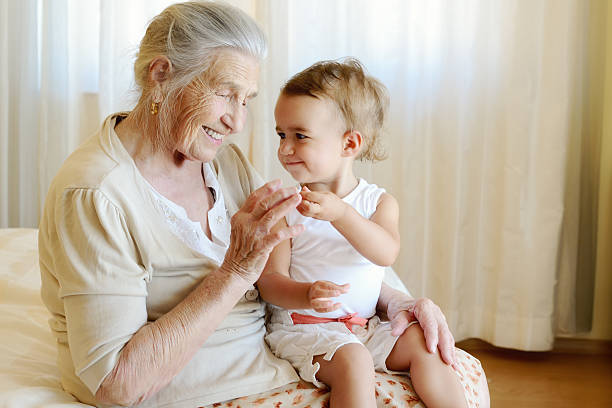 porträt eines babys und urgroßmutter - great grandmother stock-fotos und bilder