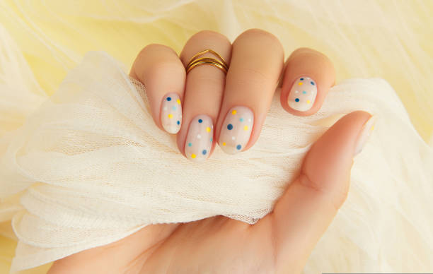 istock Womans hand with trendy polka dot summer manicure 1543544136