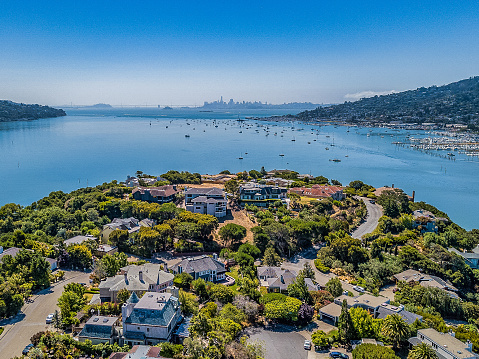 Aerial View above Tiburon with San Francisco skyline in the distance. Luxury homes below.