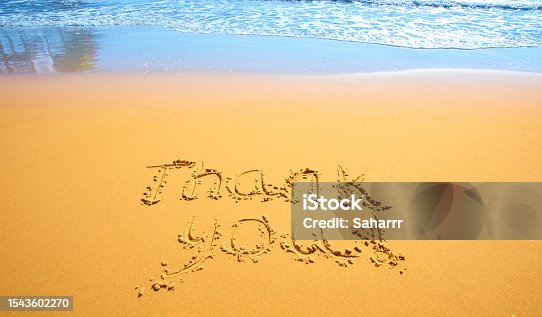 istock Concept or conceptual hand drawn thank you text carved in a golden sandy beach 1543602270