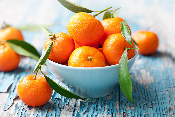 fresh oranges bowl of fresh mandarins, also looks like oranges tangerine stock pictures, royalty-free photos & images