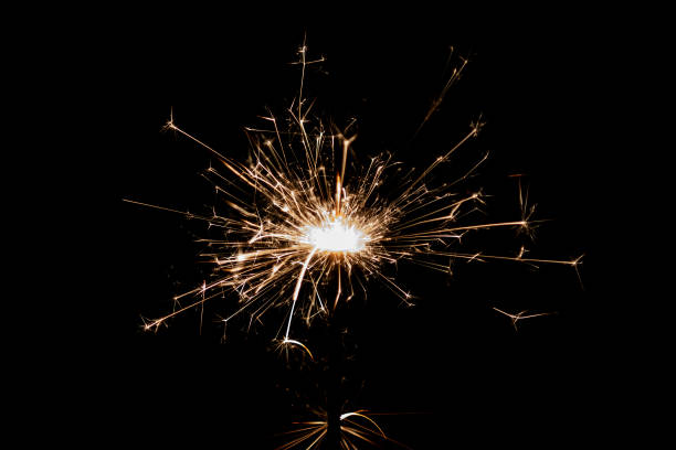 istock Burning sparkler isolated on black background. Fireworks theme. Light effect and texture. 1543612795