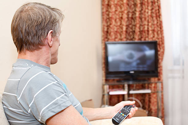 istock Mature man watching TV in domestic room 154361467