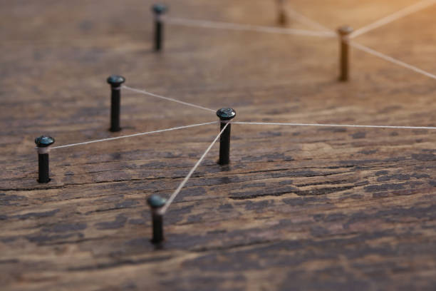 istock Network connected with yarn white on plank wood 1543652324