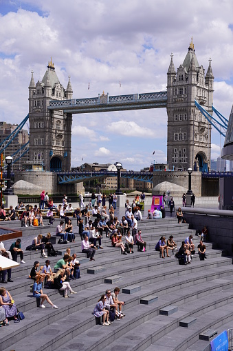 The stock photo shows the iconic historic London landmark Tower Bridge which is located in the City of London, England, United Kingdom, Great Britain. Captured on a sunny and bright day in July, in the summer of 2023. The Tower Bridge in London on a beautiful summer day, England, United Kingdom. An iconic landmark. An engineering marvel. A symbol of London. Tower Bridge is indeed all of that, but also a muse, a source of inspiration to many artists.