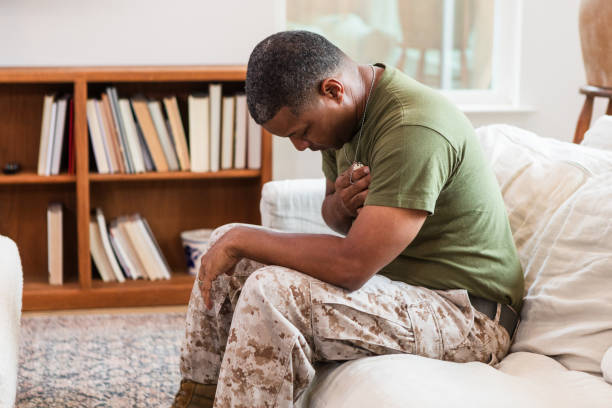 istock Remembering fallen friend, male soldier bends head and closes eyes 1543680502