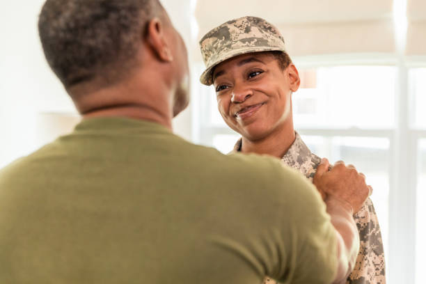istock Over-the-shoulder view father talking to smiling soldier daughter 1543680752