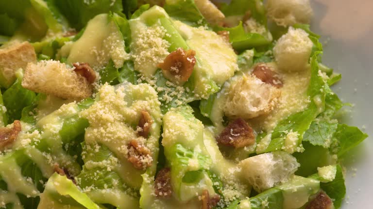 Delicious Caesar salad with Parmesan cheese, croutons and dressing.