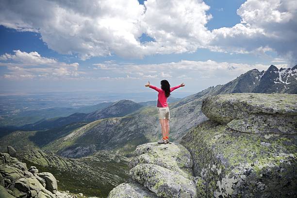 istock open arms cross woman at top summit mountains touch clouds 154370629