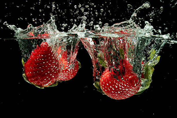 istock Strawberries splashing into water 154370645
