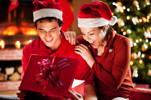 istock Cheerful couple opening Christmas presents. 154376291
