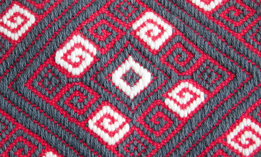 close-up of a beautiful and colorful mexican textile with rhombuses