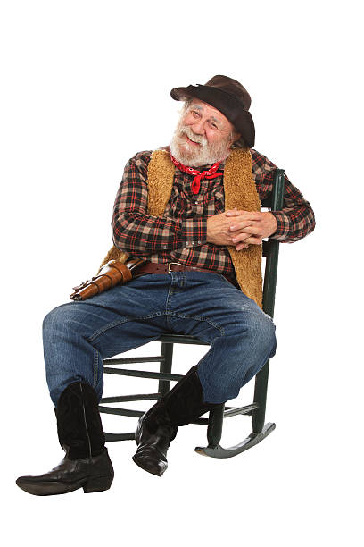 istock Happy old cowboy sits in rocking chair 154378098