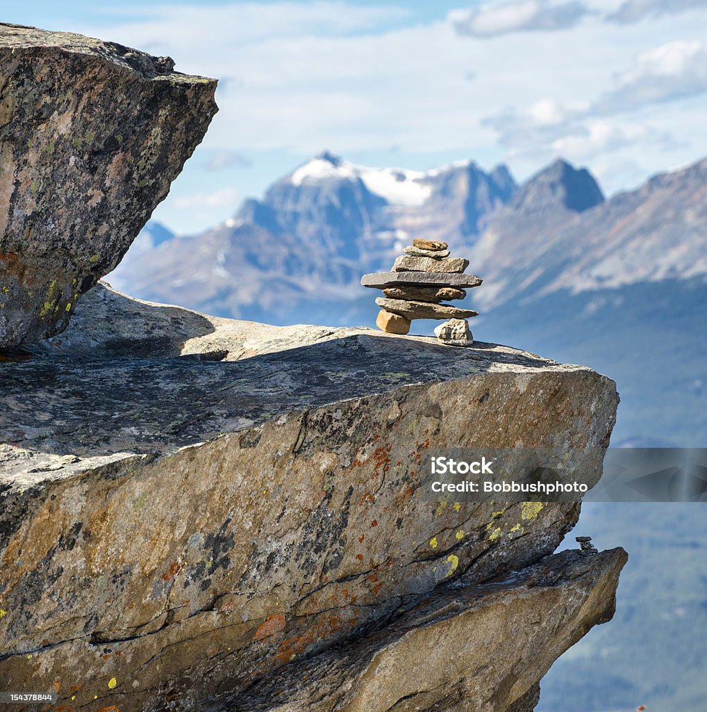 Inukshuk On Rocky Mountain ledge Inukshuk perched on ledge in the Canadian Rocky Mountains Alberta Stock Photo