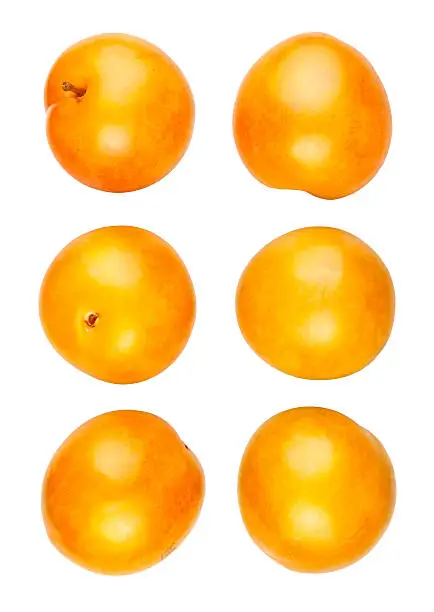 various yellow plums on white background