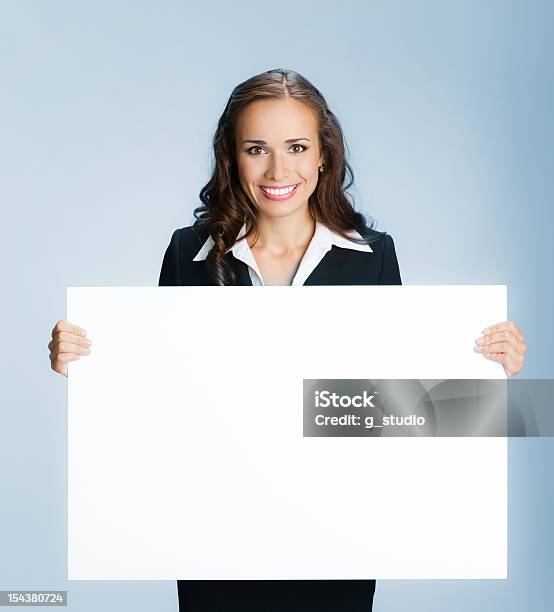 Smiling Businesswoman Holding A Blank Sign Board Stock Photo - Download Image Now - 20-29 Years, Adult, Adults Only