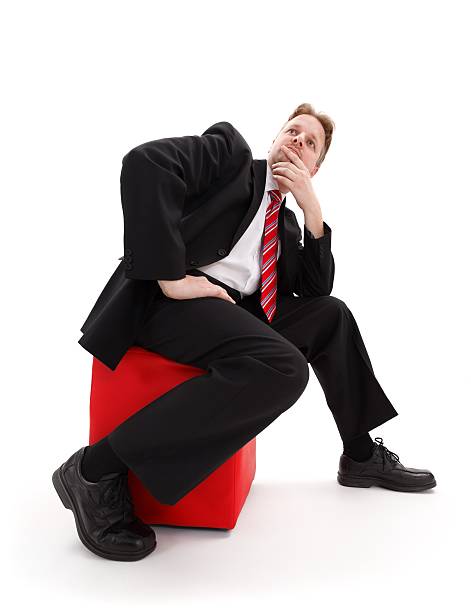 istock Businessman sitting on red tabouret 154380853