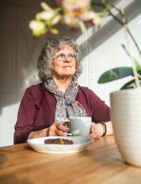 istock Senior woman thinking while having coffee at home 1543829334