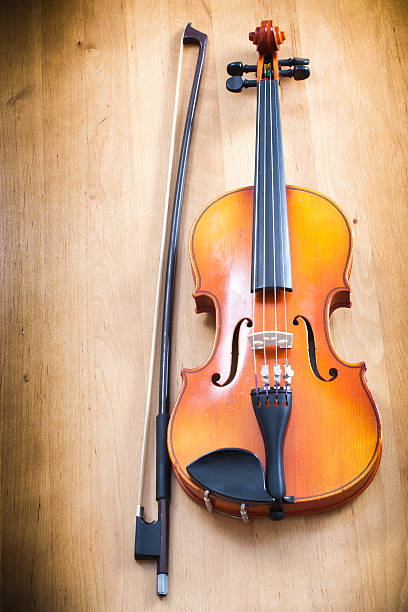 Close up of violin on wooden background stock photo