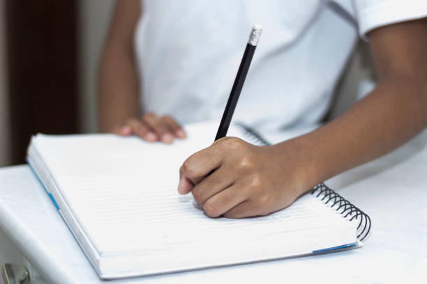 istock Hands of a child studying Doing Her Homework 1543888176