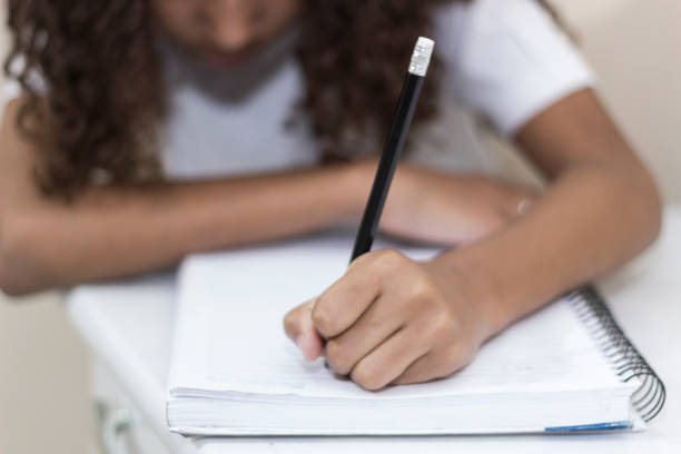 Hands of a child studying Doing Her Homework