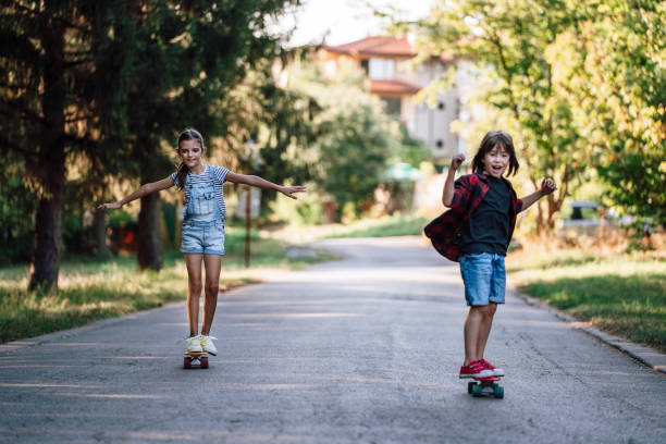 istock Happy Kids with skateboards having fun in the nature. 1543896540