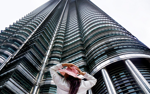 One Asian woman in Kuala Lumpur cityscape , Malaysia