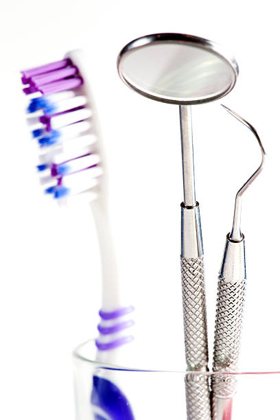istock Toothbrush and Dental mirror - explorer in glass 154393330