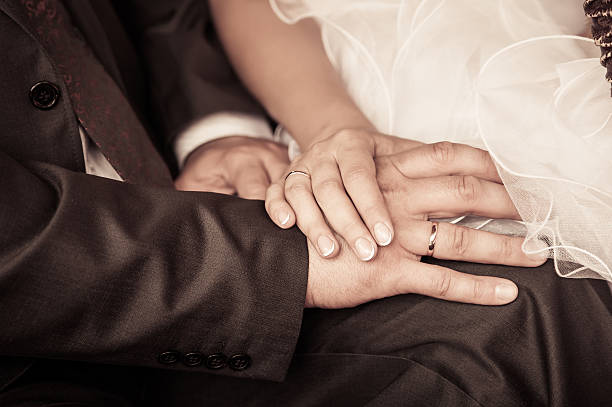 bride and groom to hold hands. loving care. retro photo stock photo