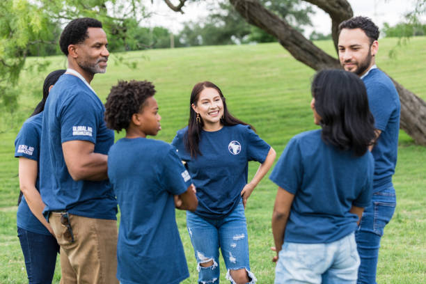 istock Young adult female talks with her volunteer group and introduces herself 1543944552