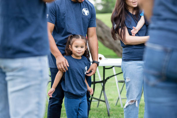 istock Young girl smiles for the camera while standing with her dad 1543945078