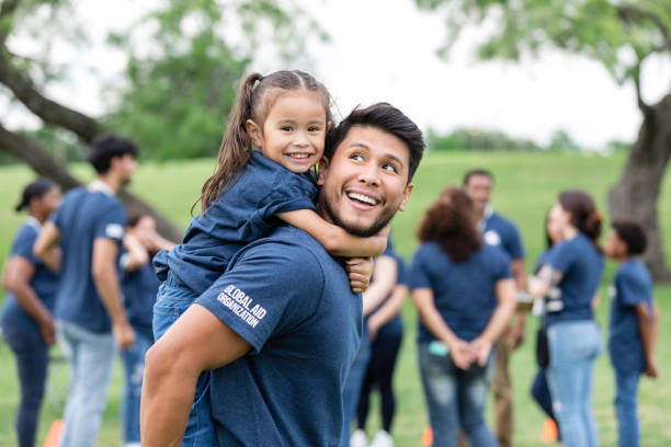 istock Young girl smiles for the camera while her dad carries her on his back 1543945080