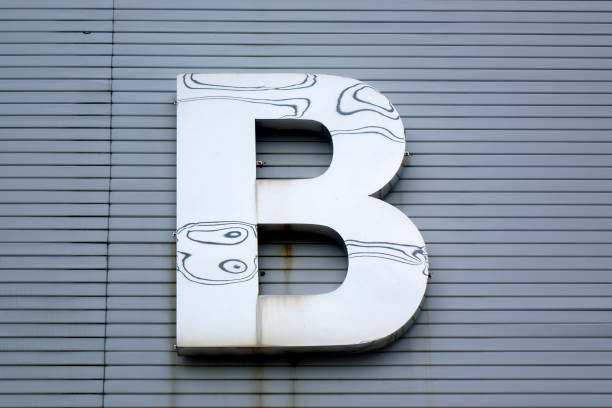 istock Close up metal letter B on building exterior wall 1543956485