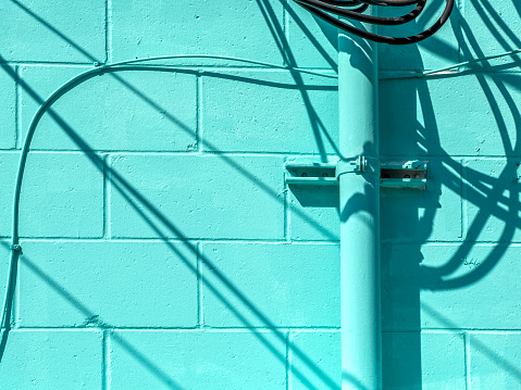 Close up utility lines on building exterior wall in Sarasota downtown, Florida
