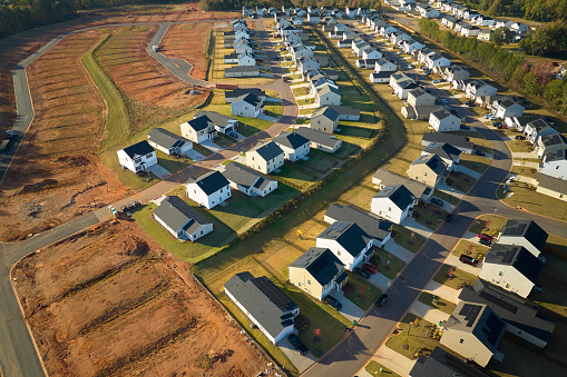 Aerial view of construction site with new tightly packed homes in South Carolina. Family houses as example of real estate development in american suburbs.