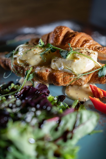 delicious croissant with scrambled eggs and sprouts microgreen