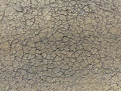 Directly above cracked asphalt texture background