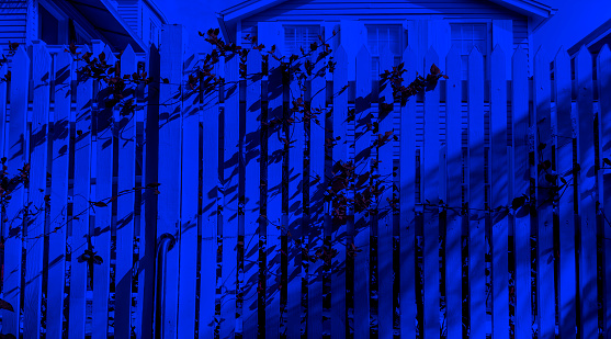 Wooden fence of residential building at night in tropical island Key West, Florida