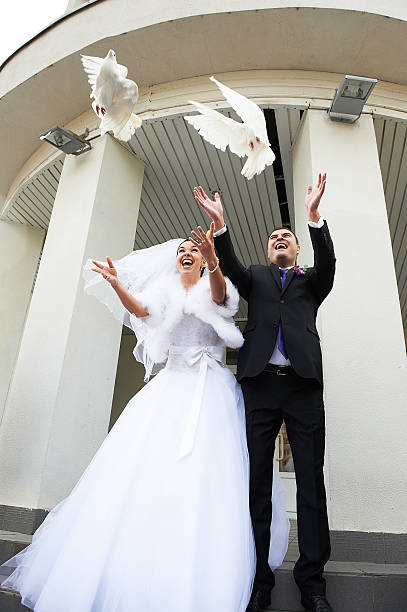 istock Joyful Bride and groom release pigeons 154400060