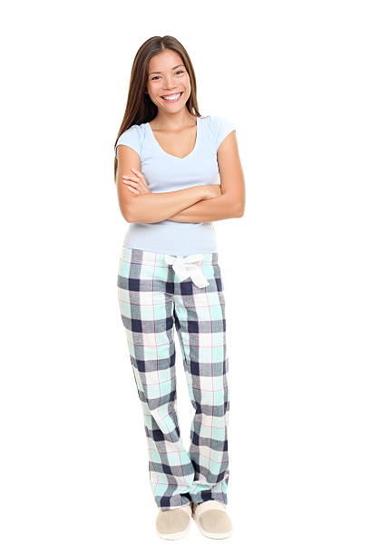 Woman standing in pajamas Woman standing in pajamas smiling isolated on white background in full length. Mixed race Asian / Caucasian female model. pajamas stock pictures, royalty-free photos & images