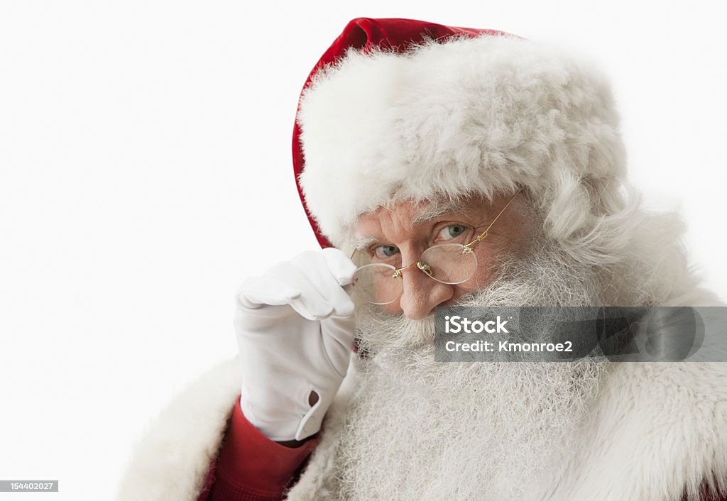 Close up of Santa claus touching his eye glasses Close up of Santa claus touching his eye glasses looking at camera, horizontal composition, Isolated on a white background Santa Claus Stock Photo