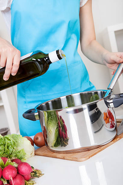 istock Cheerful young woman cooking 154402477